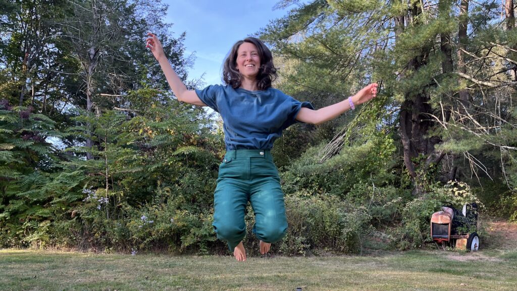 Home Susan jumping in the grass